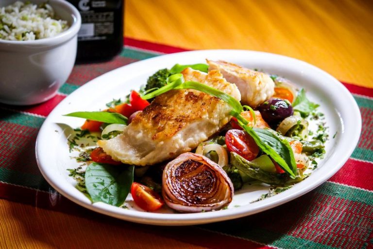 Roasted vegetables beside a balanced paleo meal