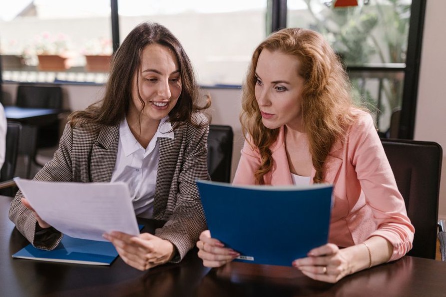 Teammates check a document before sharing