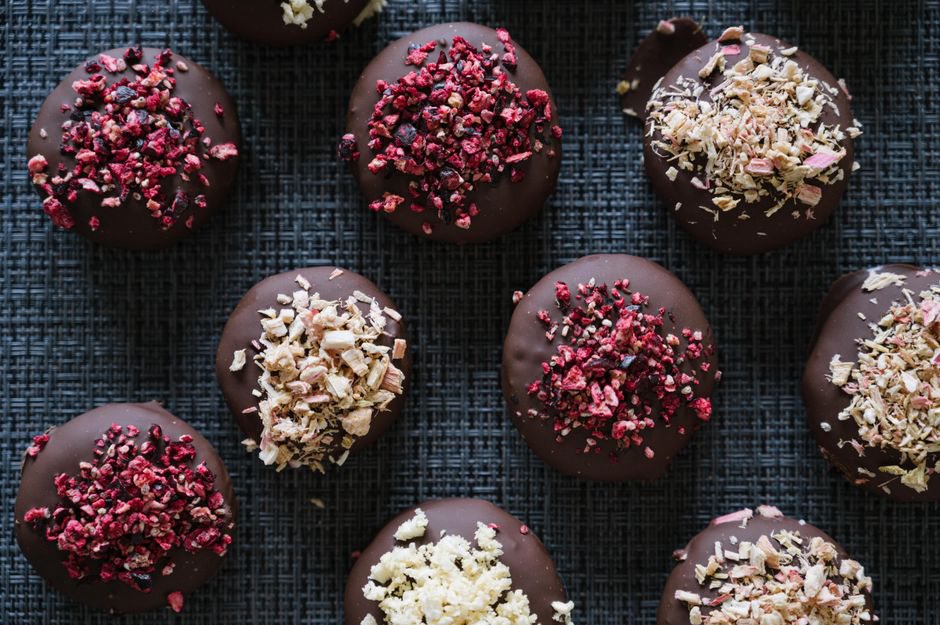 Small chocolate cups beside fresh berries