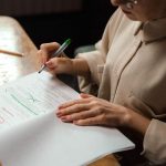 Printed draft with notes beside a review checklist