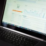Landing page report open beside a notebook