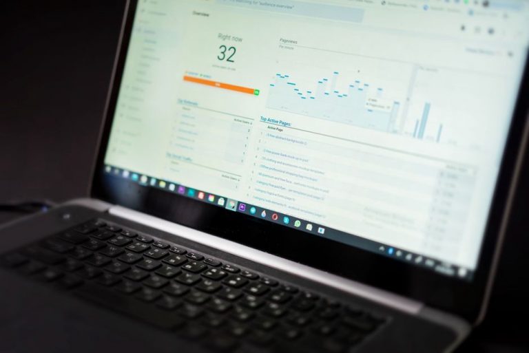 Landing page report open beside a notebook