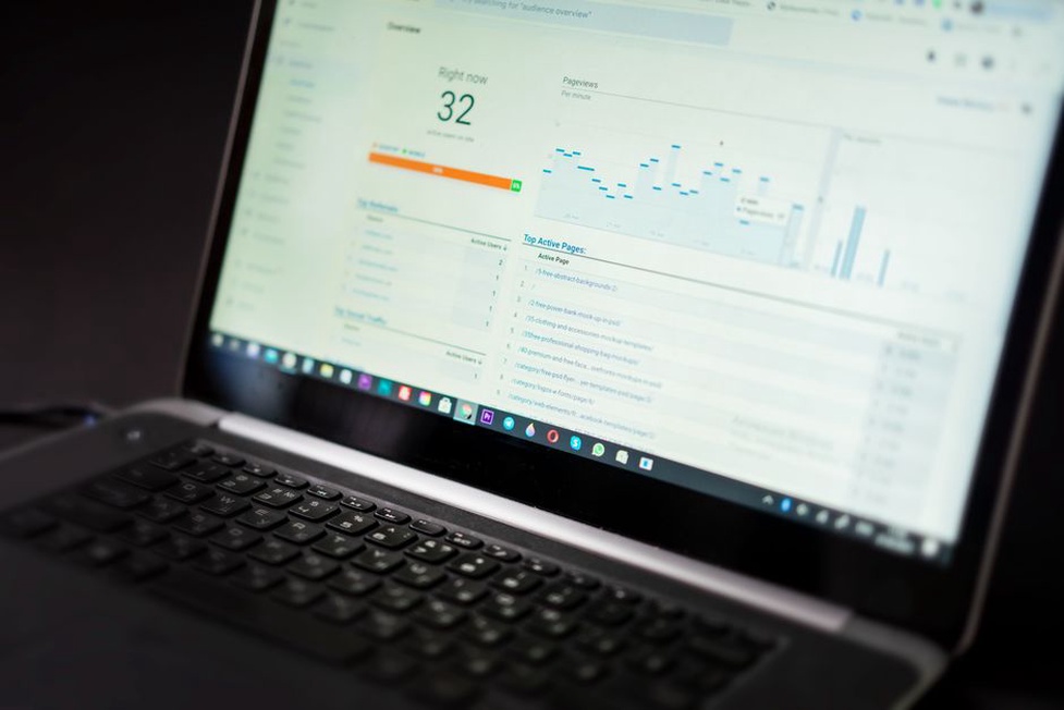Landing page report open beside a notebook