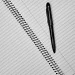 A notebook records meals and symptom times