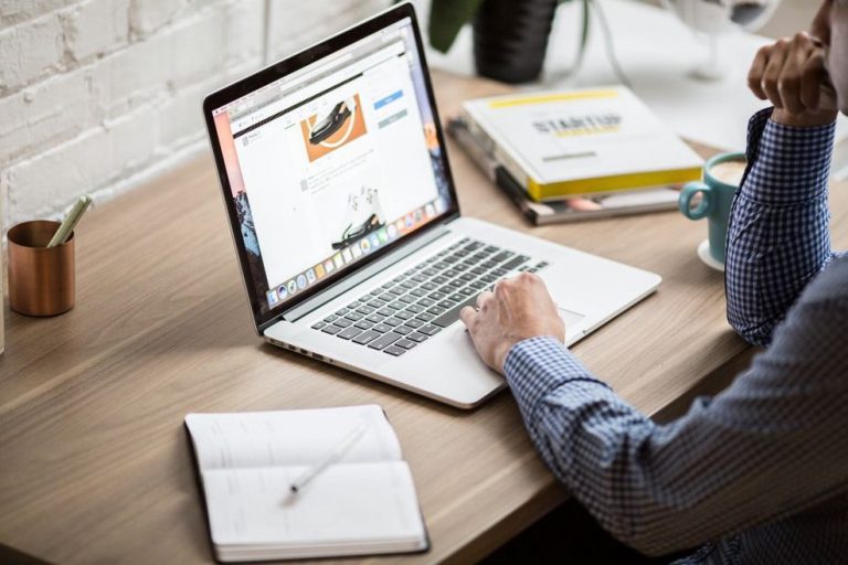 Notes comparing nutrition blog topics on a laptop