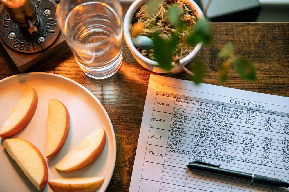 A notebook tracks meals alongside sleep times