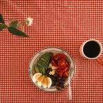 Ingredients arranged beside a home-cooked meal