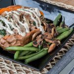 Salmon served with greens and roasted sweet potato