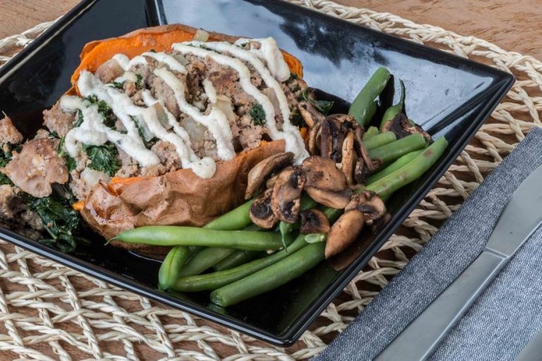 Salmon served with greens and roasted sweet potato