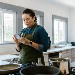Cook checks recipe details on a phone