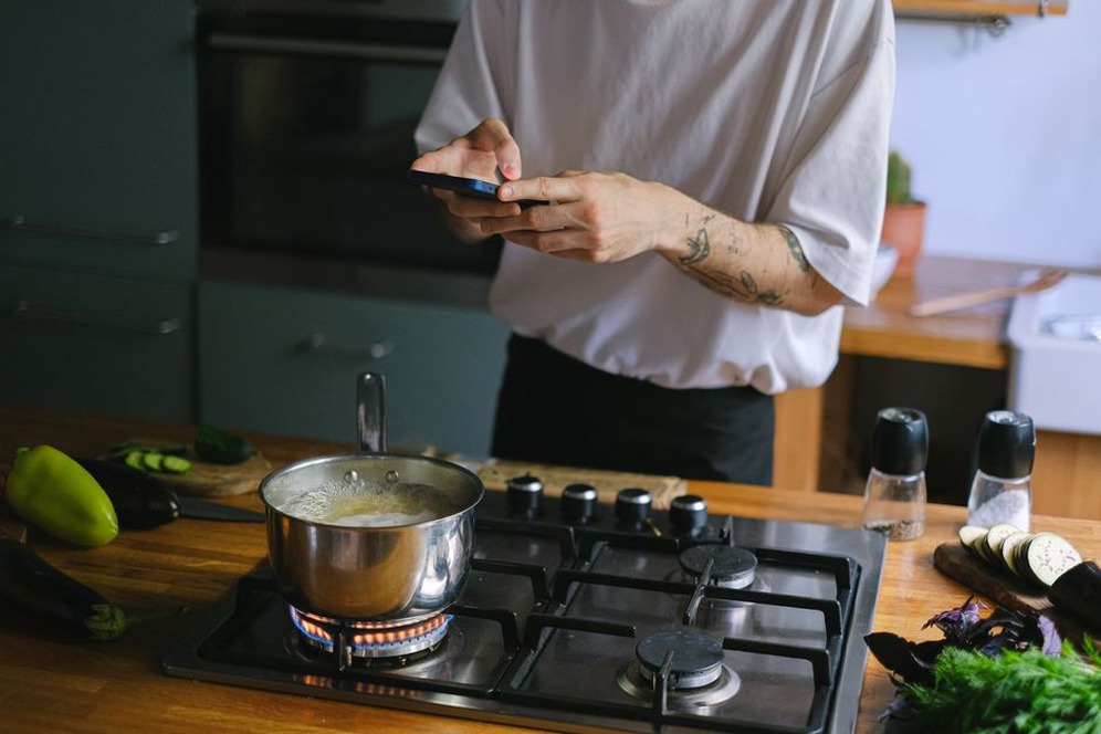 Reader checks a recipe beside prepared ingredients