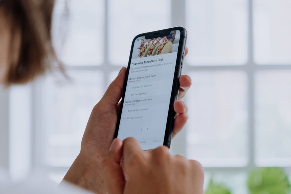 A visitor checks the menu on a phone