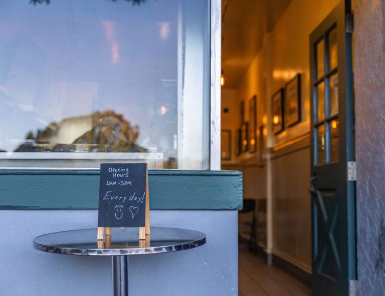 Bakery entrance with opening hours by the door