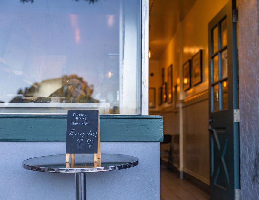 Bakery entrance with opening hours by the door