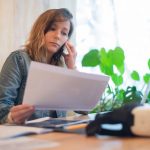 Website metrics beside a handwritten planning notebook