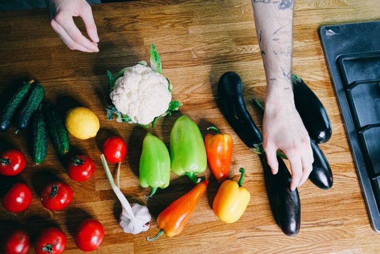 Tomatoes, peppers, and eggplant beside other vegetables