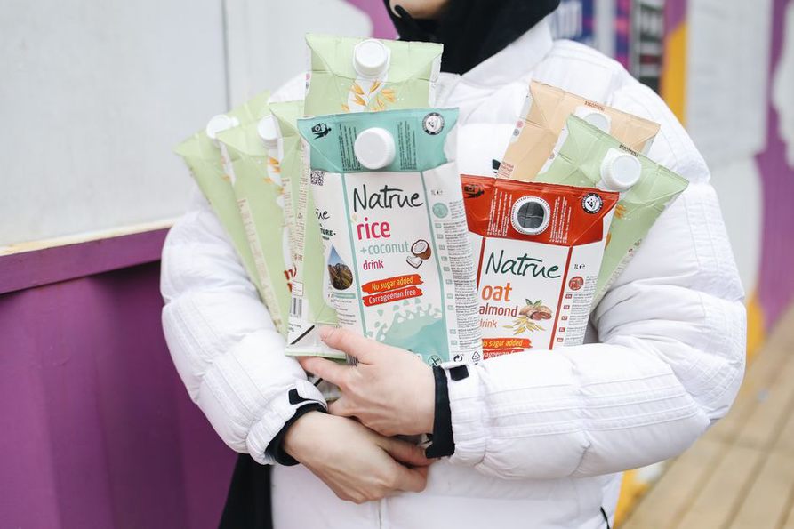 Plant-based drinks beside a breakfast bowl