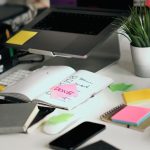 Notes beside a laptop during a site review