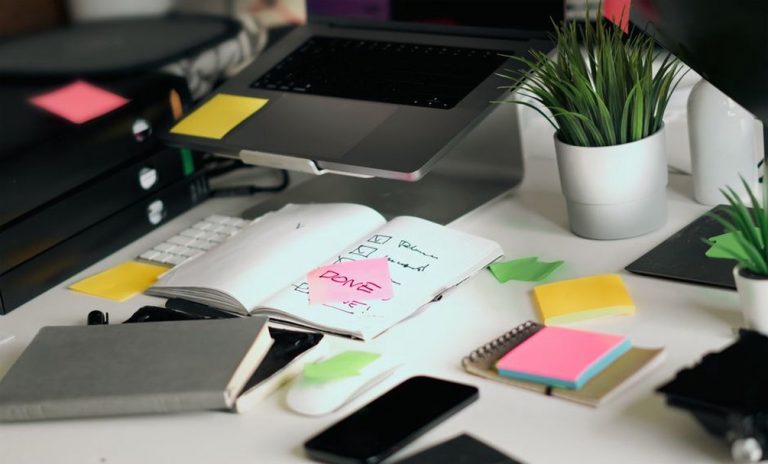 Notes beside a laptop during a site review
